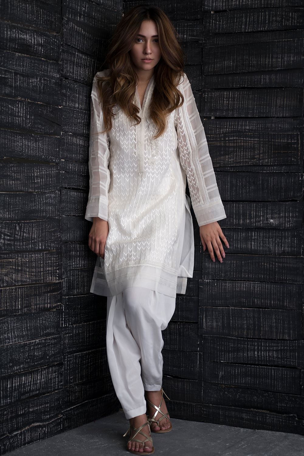 shirt with hand work with camisole paired with White crepe silk khadi shalwar making it a perfect attire for you evening get together