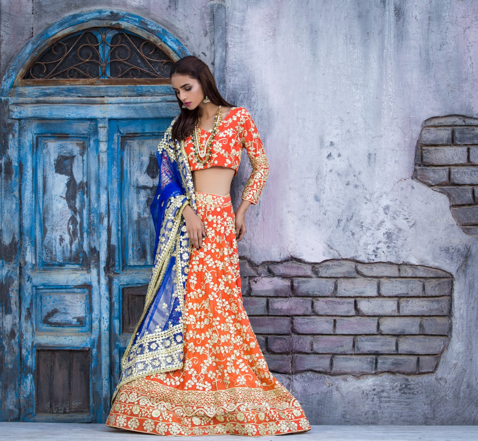 orange silk lehenga with gold gota patti work adorning the hemline by Sanober Azfar Lehanga collection