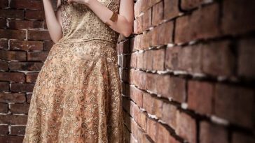 A beautiful peachy and dusk gold color Pakistani wedding dress by Umsha
