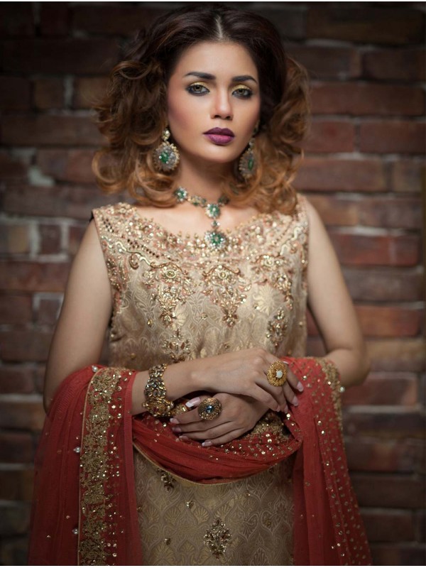 This brocade Pakistani dress by Umsha in light gold color