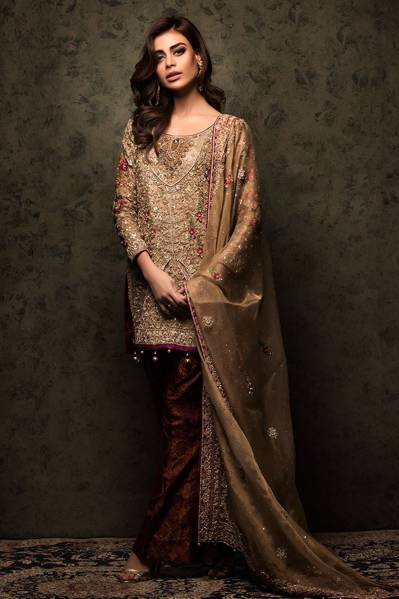 A very traditional brown and golden shirt embellished with zardozi and thread work