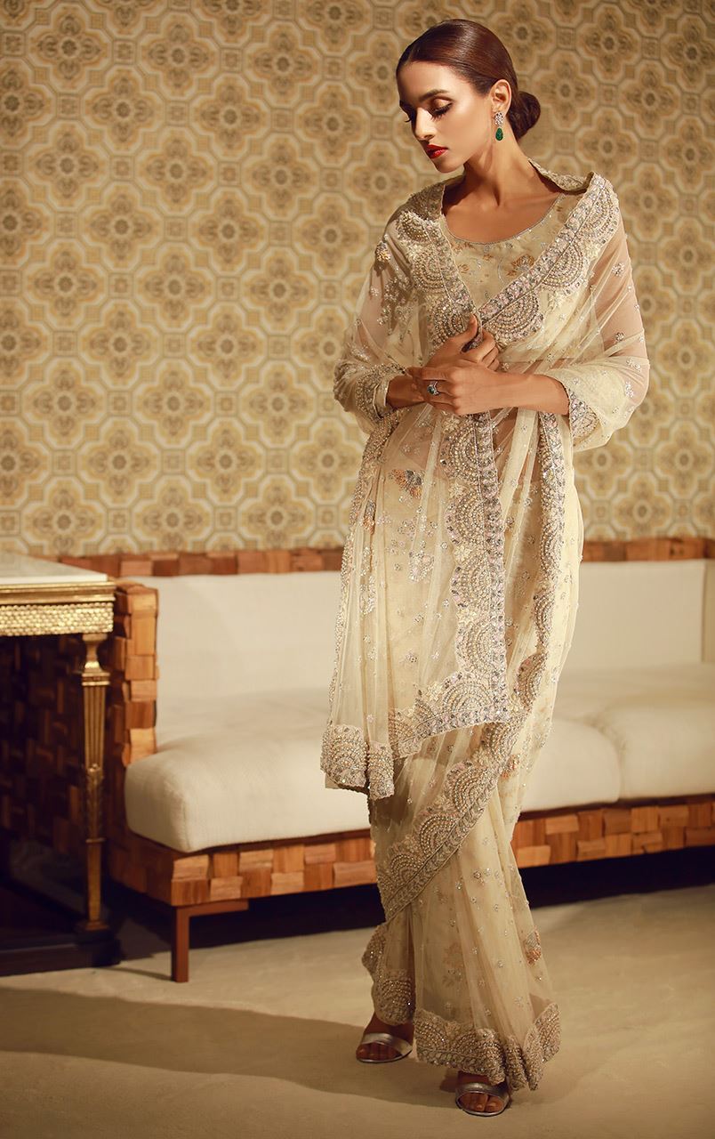 Ivory net skirt sari with hand worked borders on all edges by Tena Durrani