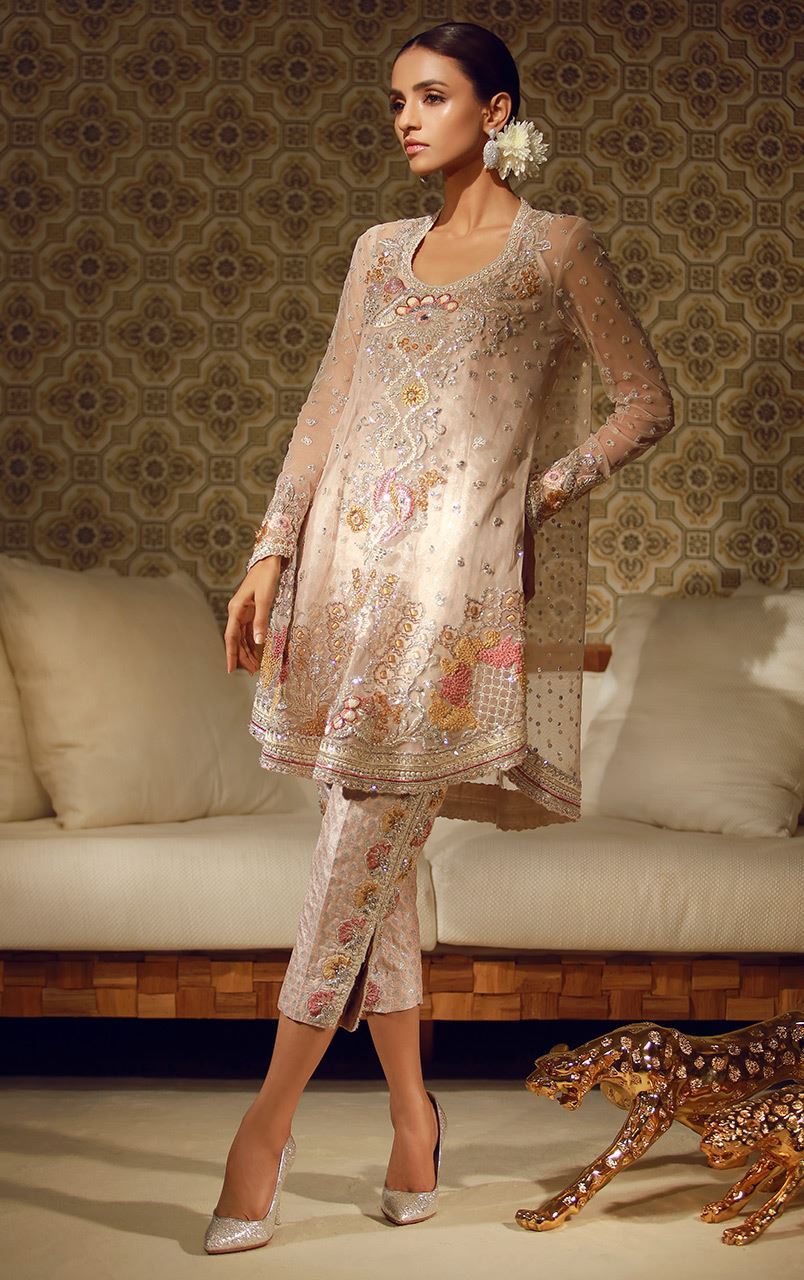 Pakistani wedding dress by Tena Durrani Pale pink net shirt with rounded neckline embellished