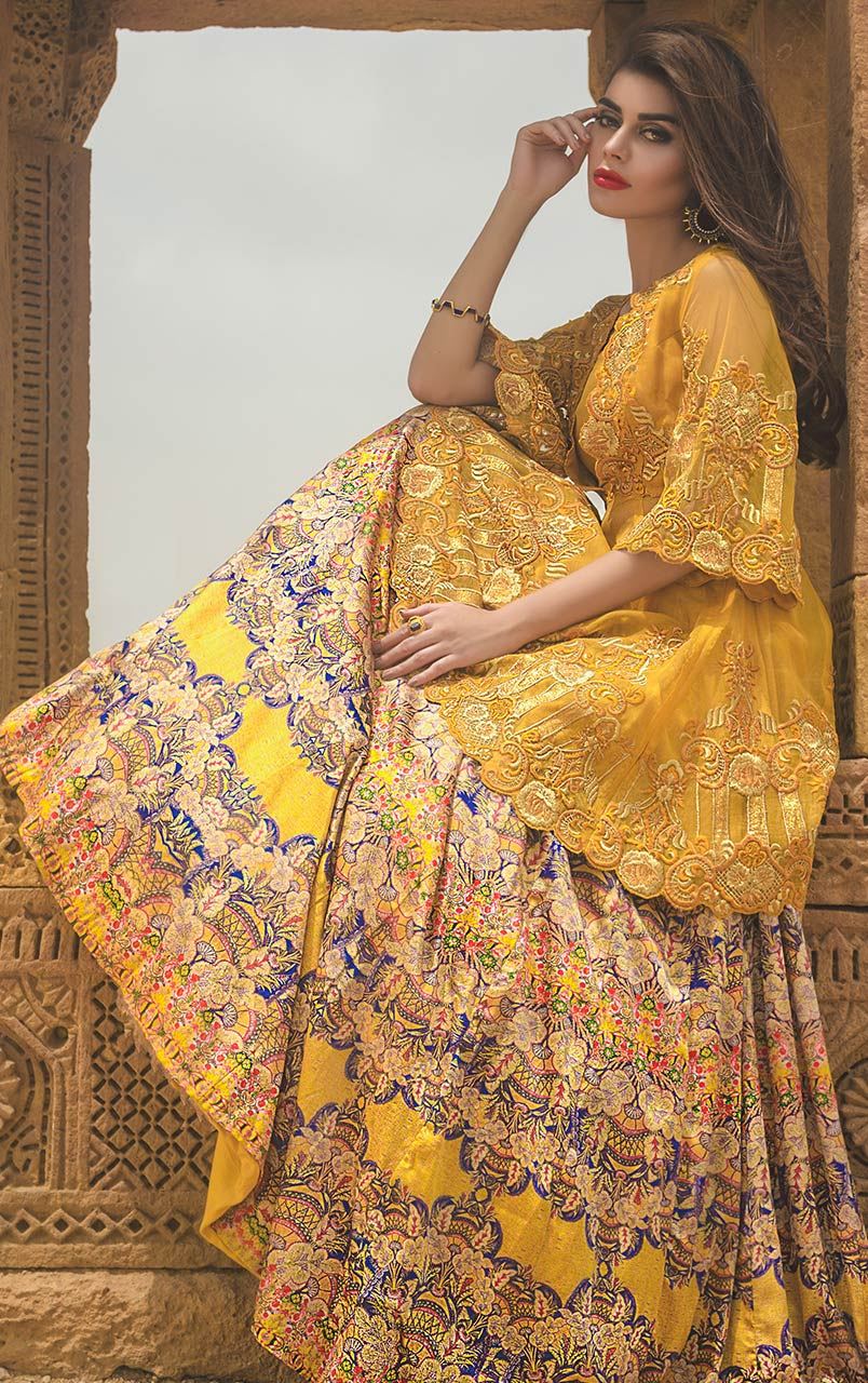 Pakistani wedding dresses by Tena Durrani yellow net peplum cut shirt with a deep V-neck