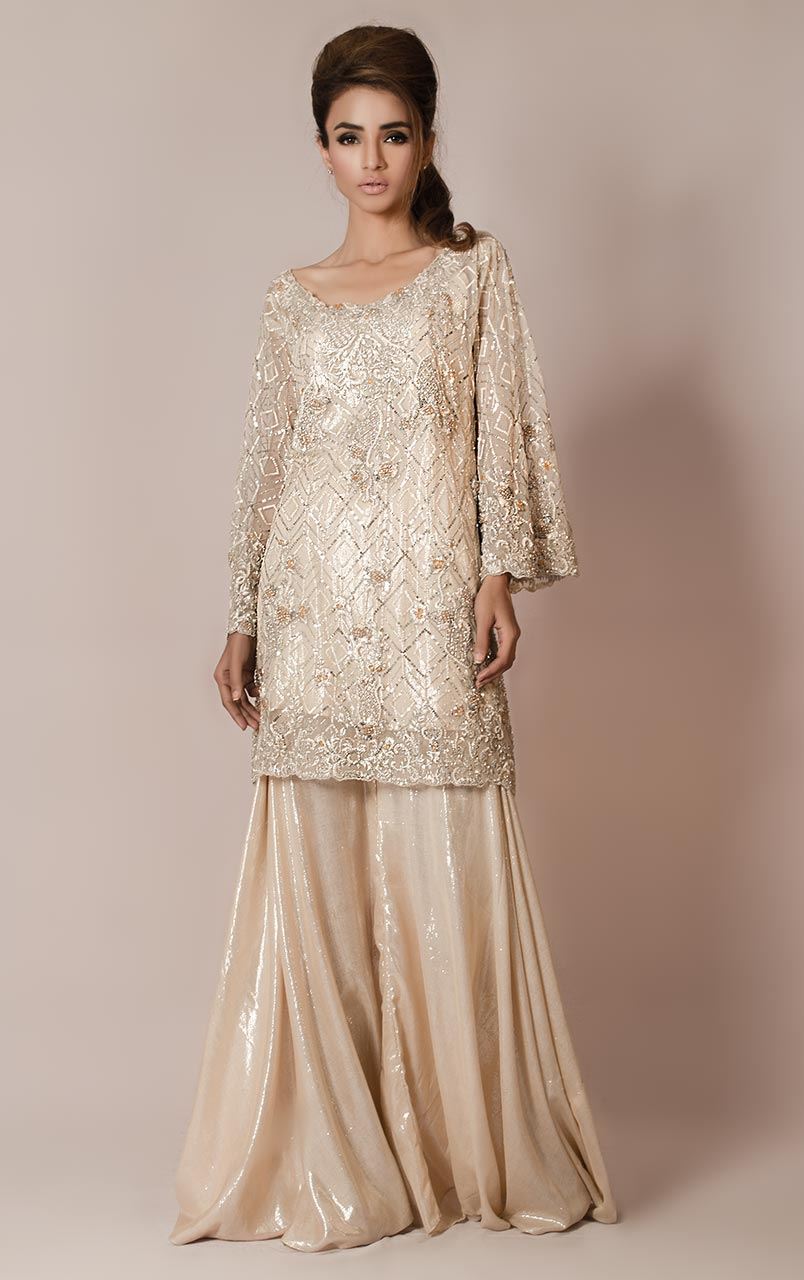 Short kurta cut shirt.Also, cut worked round neckline embellished with sequins, pearls, beads